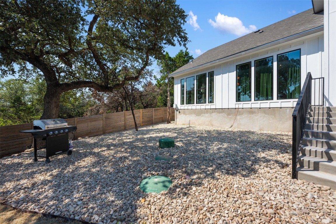 1301 Scenic Circle Spicewood, TX 78669 - Photo 20 of 39 a backyard of a house with table and chairs