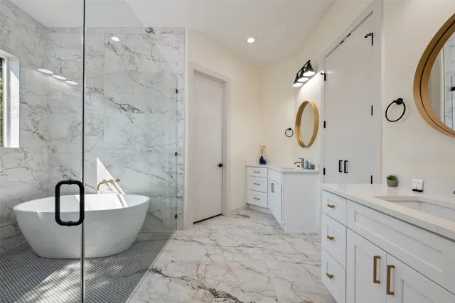 a bathroom with a double vanity sink mirror and shower