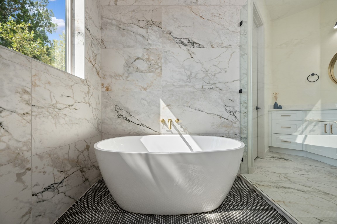 1301 Scenic Circle Spicewood, TX 78669 - Photo 26 of 39 a white tub sitting in a bathroom