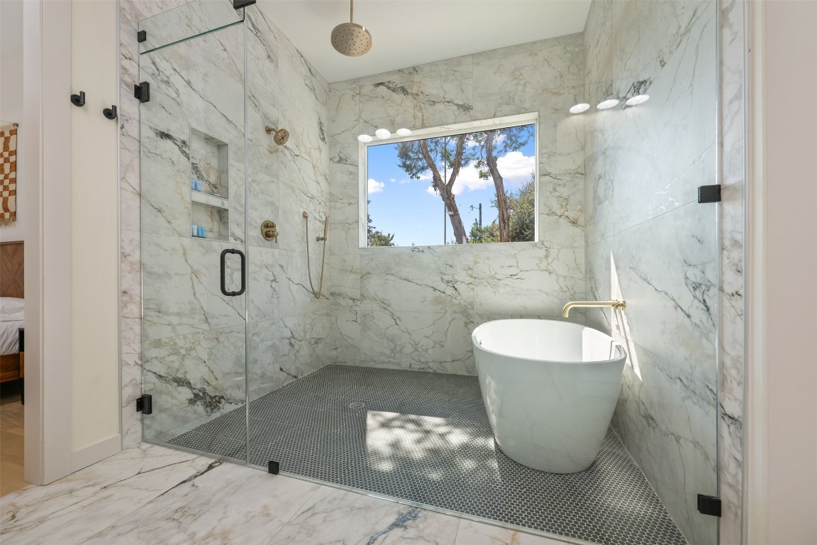 1301 Scenic Circle Spicewood, TX 78669 - Photo 27 of 39 a bathroom with a bathtub and shower