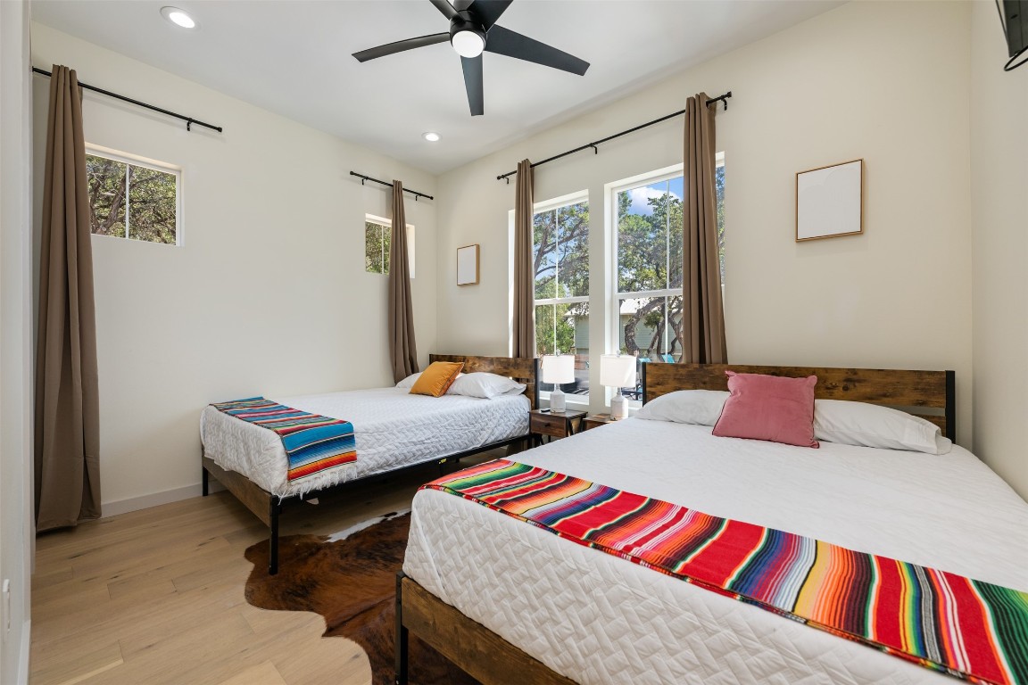 1301 Scenic Circle Spicewood, TX 78669 - Photo 30 of 39 a bedroom with a bed and a chandelier