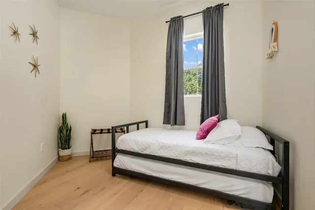 a bedroom with a bed and a window