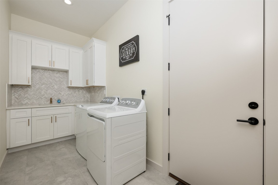 1301 Scenic Circle Spicewood, TX 78669 - Photo 36 of 39 a utility room with cabinets washer and dryer