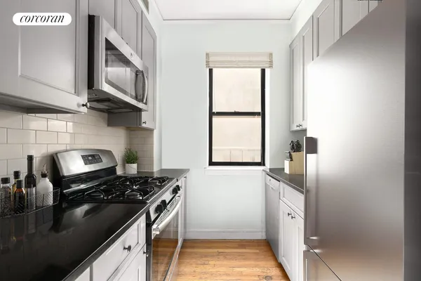 a kitchen with stainless steel appliances a sink stove and refrigerator