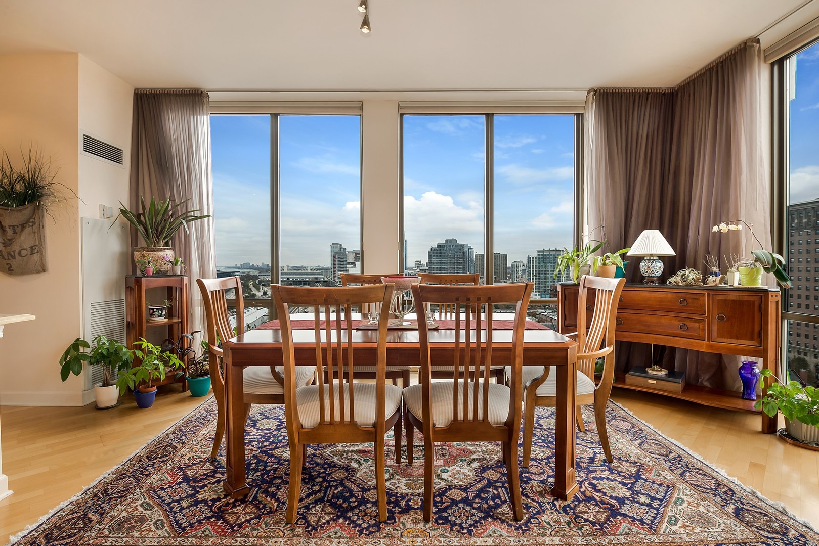1335 South Prairie Avenue, Unit 1706 Chicago, IL 60605 - Photo 8 of 16 a dining room with furniture window and wooden floor