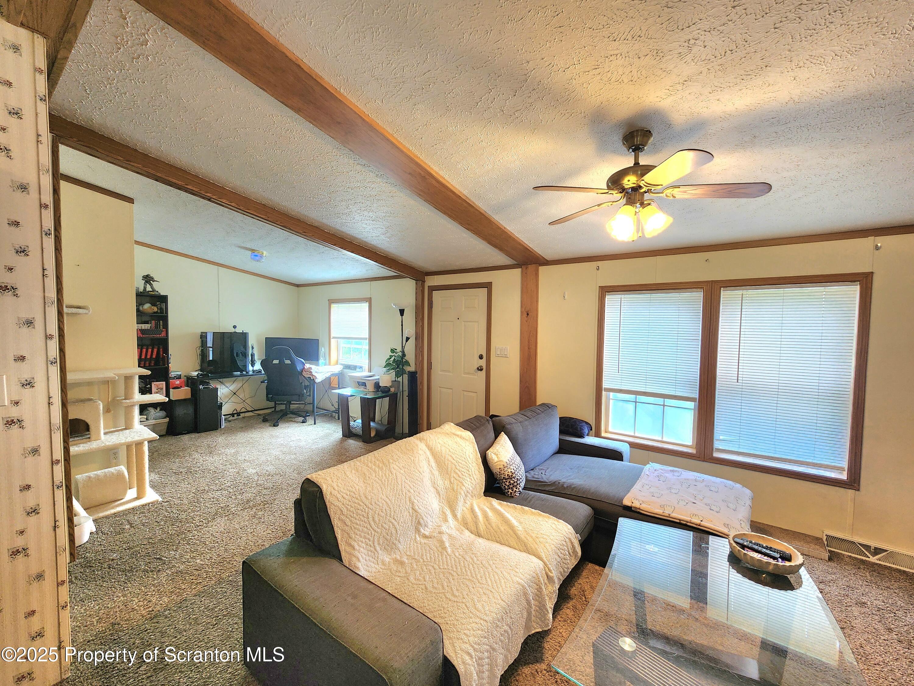 18132 Dimock To Nicholson Road Nicholson, PA 18446 - Photo 23 of 62 a living room with furniture and a flat screen tv