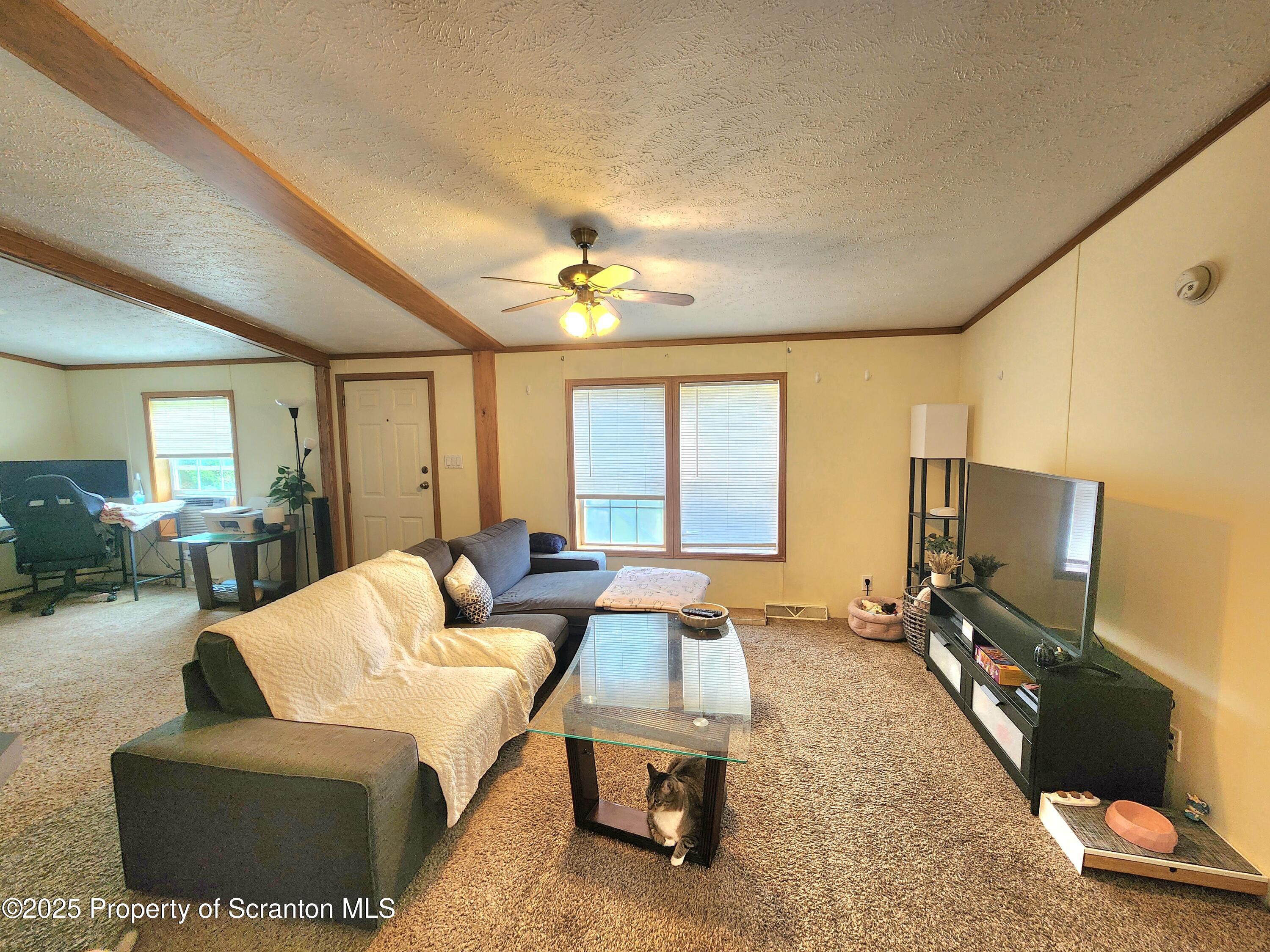 18132 Dimock To Nicholson Road Nicholson, PA 18446 - Photo 24 of 62 a living room with furniture and a flat screen tv