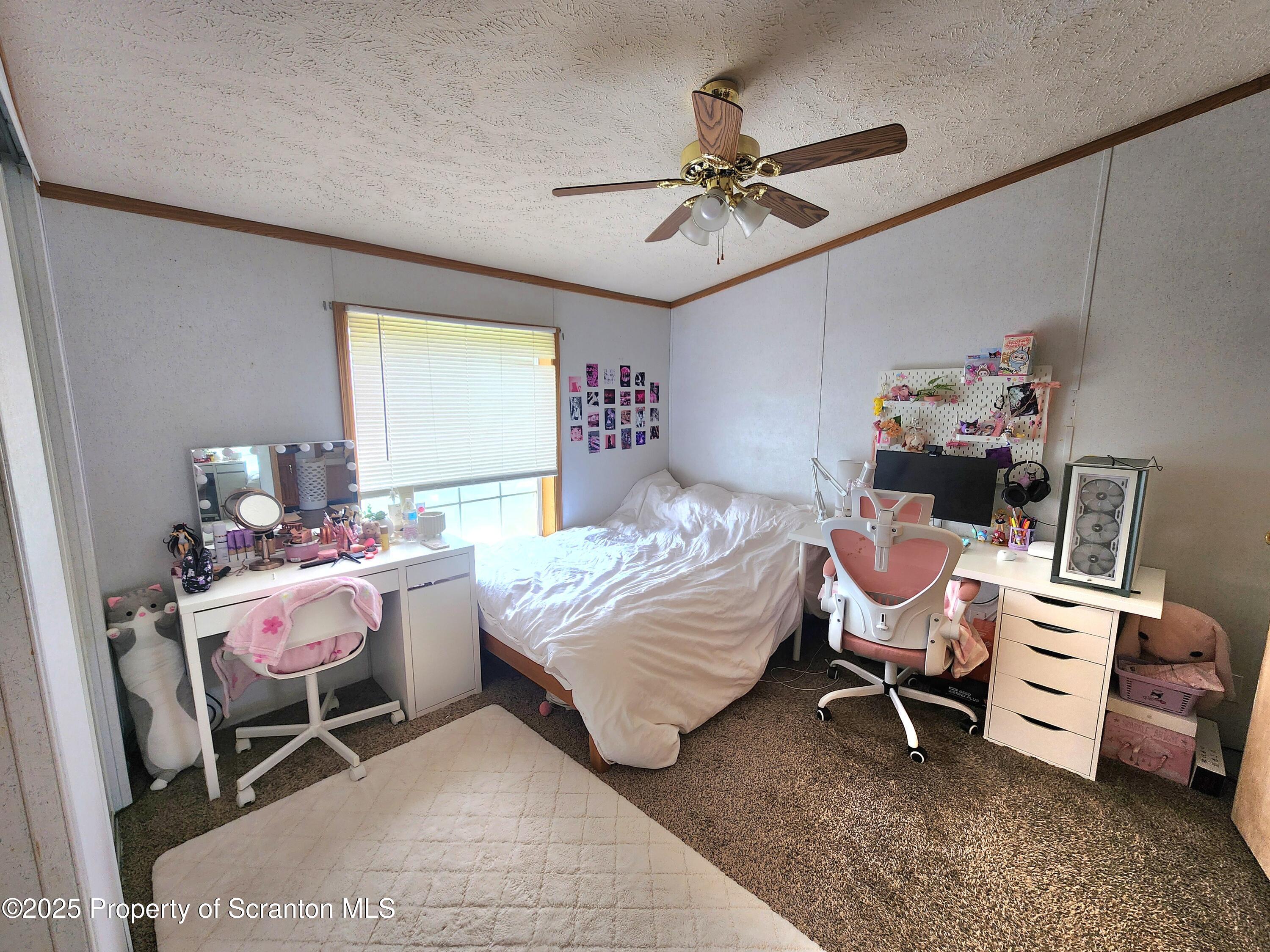 18132 Dimock To Nicholson Road Nicholson, PA 18446 - Photo 25 of 62 a bedroom with a bed and a chandelier