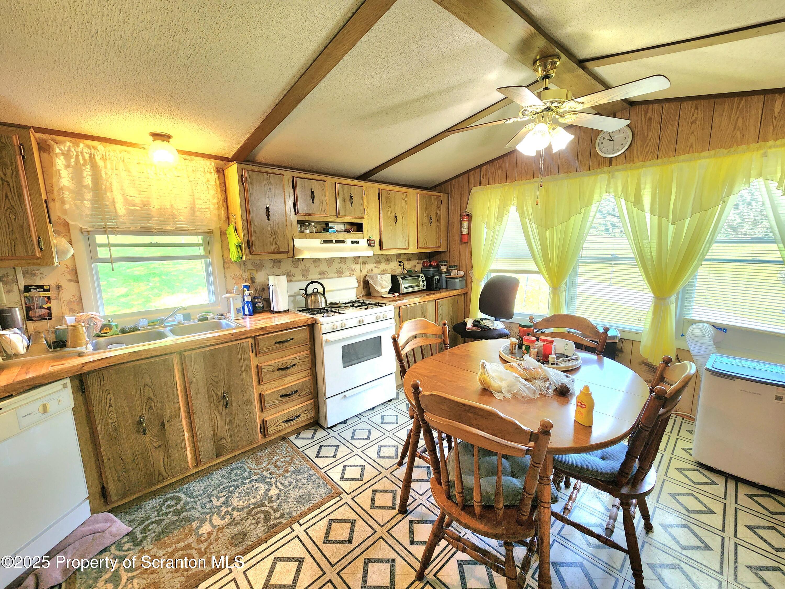18132 Dimock To Nicholson Road Nicholson, PA 18446 - Photo 39 of 62 a kitchen with a table chairs and white cabinets