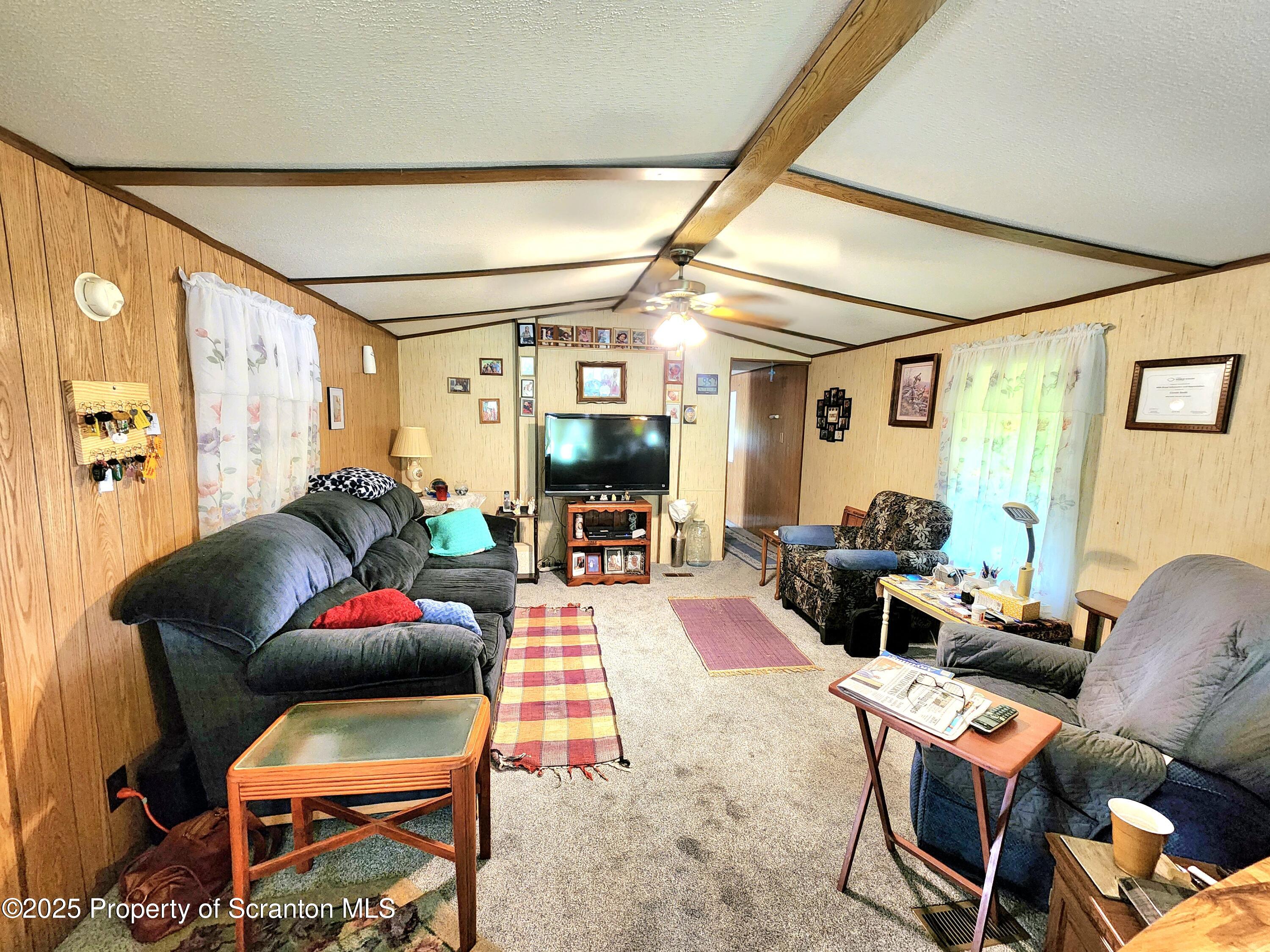 18132 Dimock To Nicholson Road Nicholson, PA 18446 - Photo 42 of 62 a living room with furniture a flat screen tv and a window