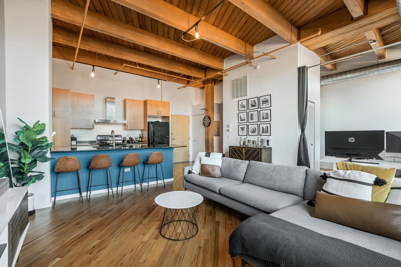 1040 West Adams Street, Unit 417 Chicago, IL 60607 - Photo 11 of 21 a living room with furniture and wooden floor