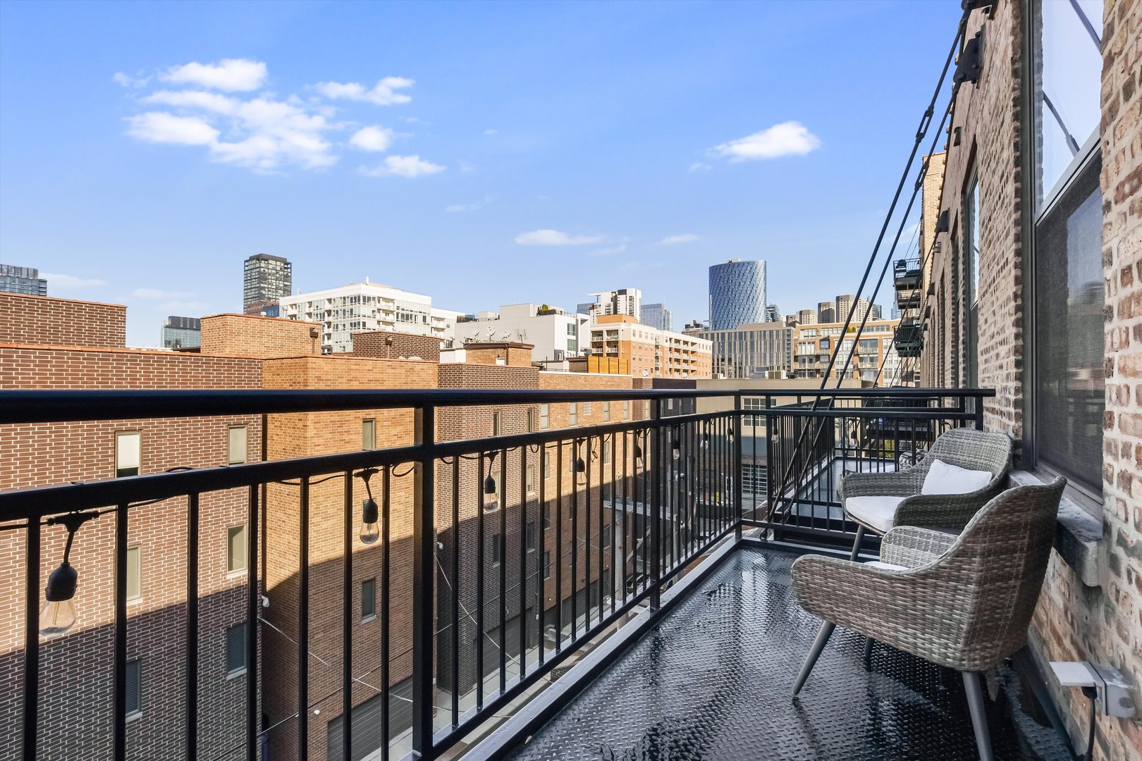 1040 West Adams Street, Unit 417 Chicago, IL 60607 - Photo 18 of 21 a view of a balcony with two chairs and a potted plant