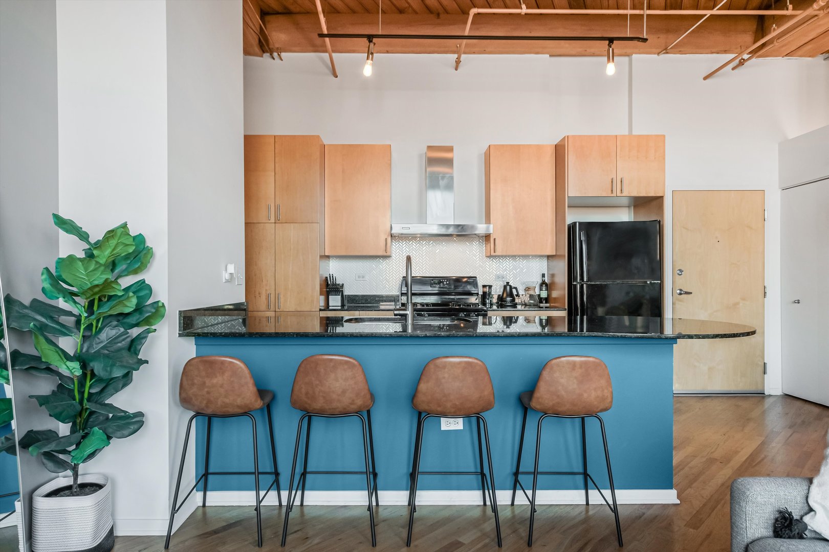 1040 West Adams Street, Unit 417 Chicago, IL 60607 - Photo 3 of 21 a kitchen with stainless steel appliances granite countertop a stove a sink and a refrigerator