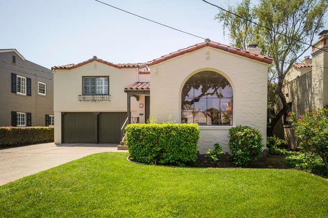a front view of a house with a garden