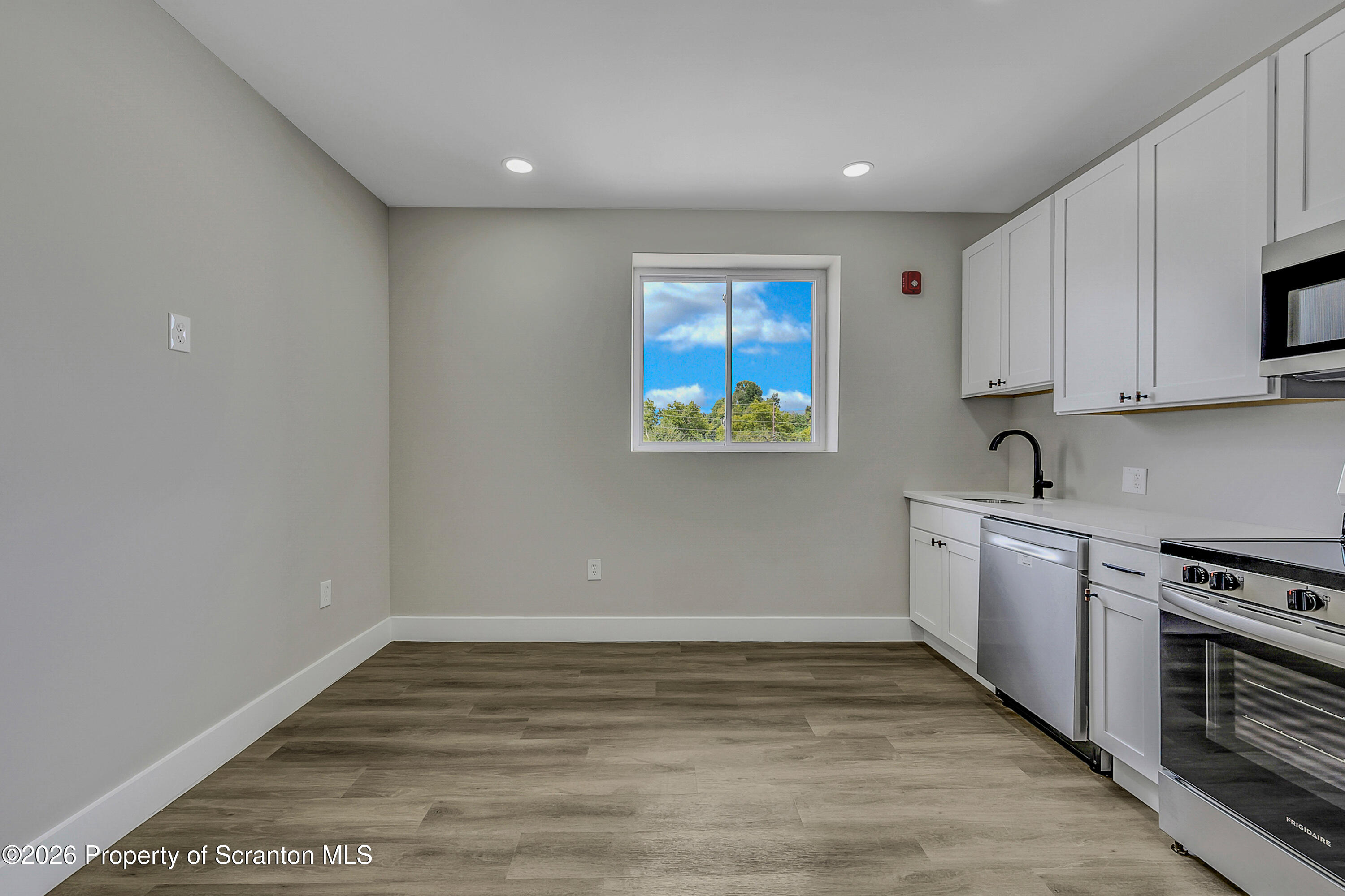 215 Hickory Street, Unit 13 Scranton, PA 18505 - Photo 1 of 13 a view of kitchen with wooden floor electronic appliances and window