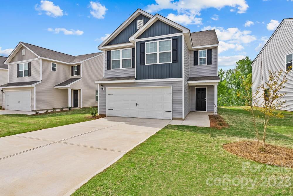 1713 Nia Road Charlotte, NC 28215 - Photo 2 of 19 a front view of a house with a yard and garage
