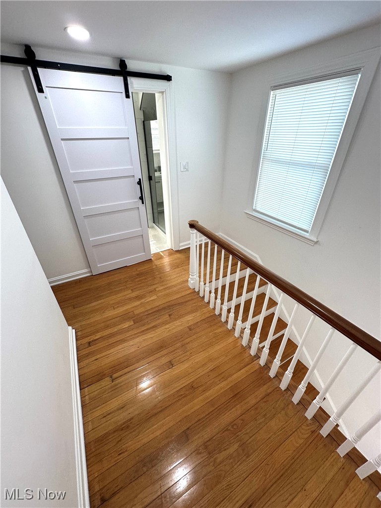 568 North Road Southeast Warren, OH 44484 - Photo 35 of 49 Stairway with a barn door, hardwood / wood-style flooring, and recessed lighting