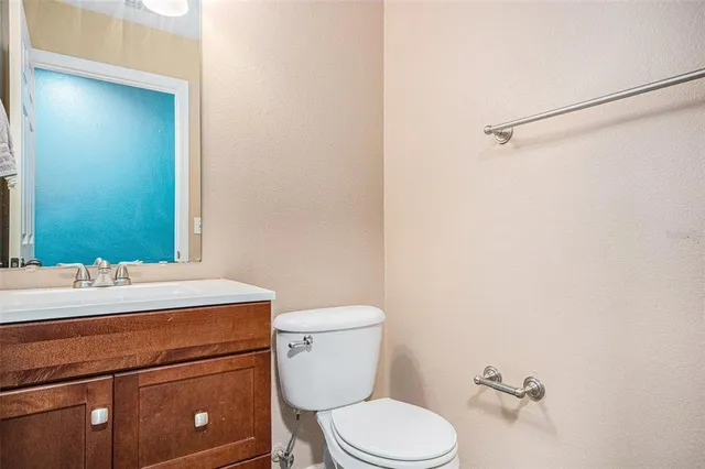 a bathroom with a sink a toilet and mirror