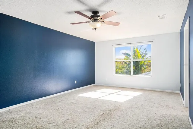 an empty room with windows and closet