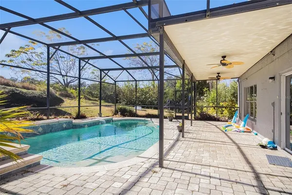 a swimming pool with patio outdoor seating and yard