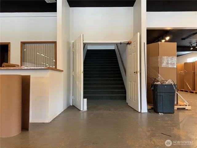 an empty room with a ceiling fan and window