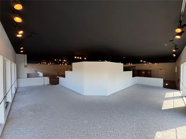 a view of an empty room with kitchen