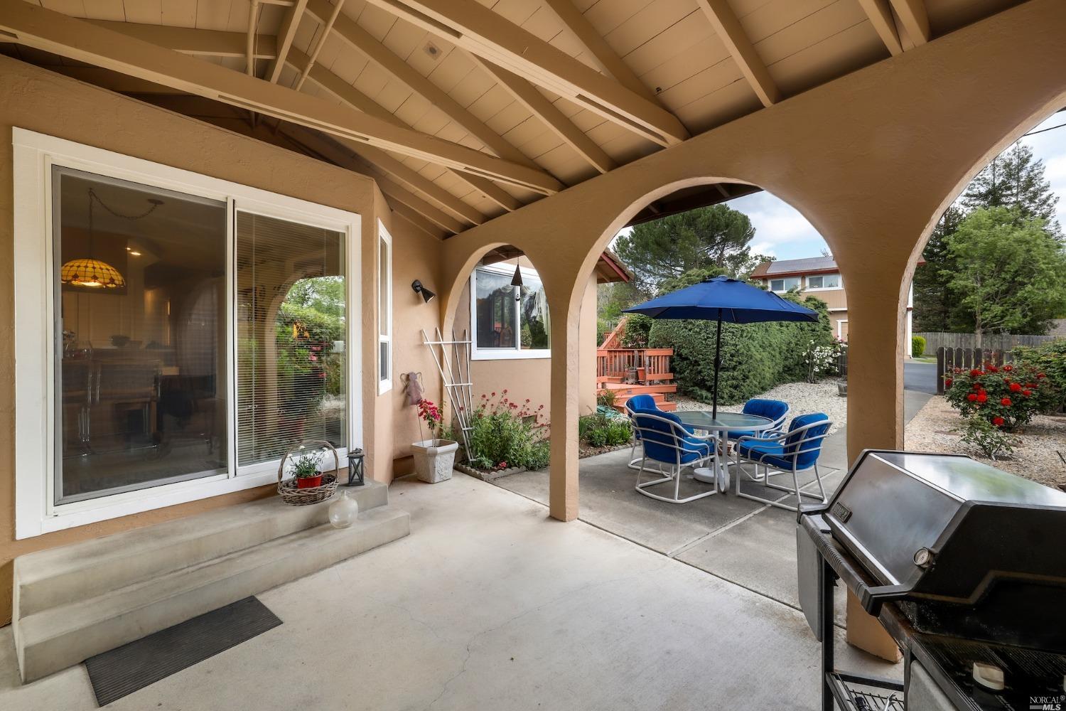 1454 Olivet Road Santa Rosa, CA 95401 - Photo 21 of 30 a view of a patio with table and chairs potted plants with wooden floor and fence