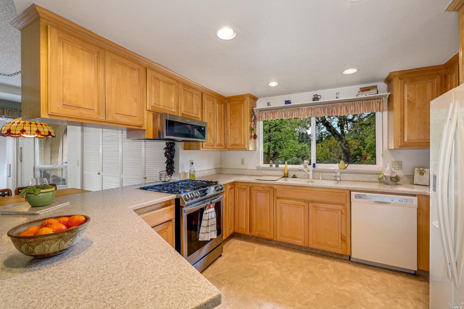 1454 Olivet Road Santa Rosa, CA 95401 - Photo 6 of 30 a kitchen with stainless steel appliances granite countertop a stove a sink and a microwave