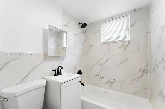 a bathroom with a sink a toilet and a bathtub