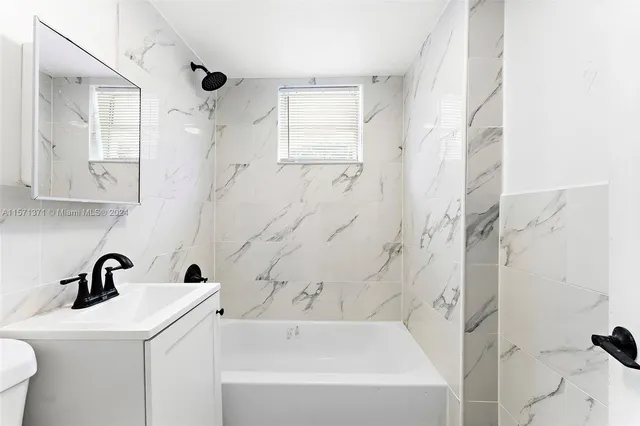 a bathroom with a sink a toilet and a bathtub