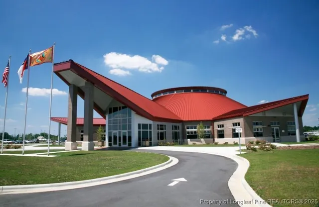 a front view of a house with swimming pool having outdoor seating