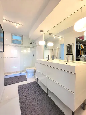 a living room with furniture and view of kitchen