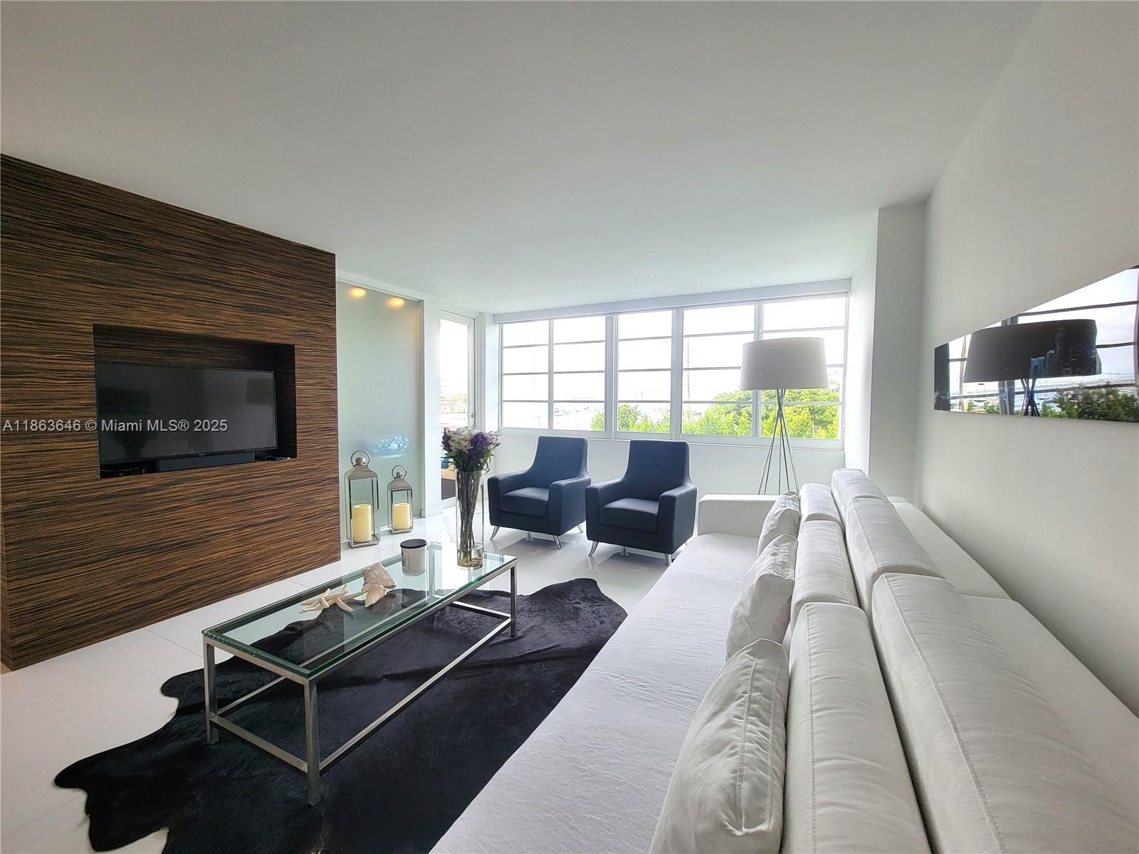 1670 Lincoln Court, Unit 3B Miami Beach, FL 33139 - Photo 6 of 13 a living room with furniture and a fireplace