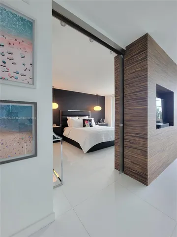 a bedroom with furniture and a lamp