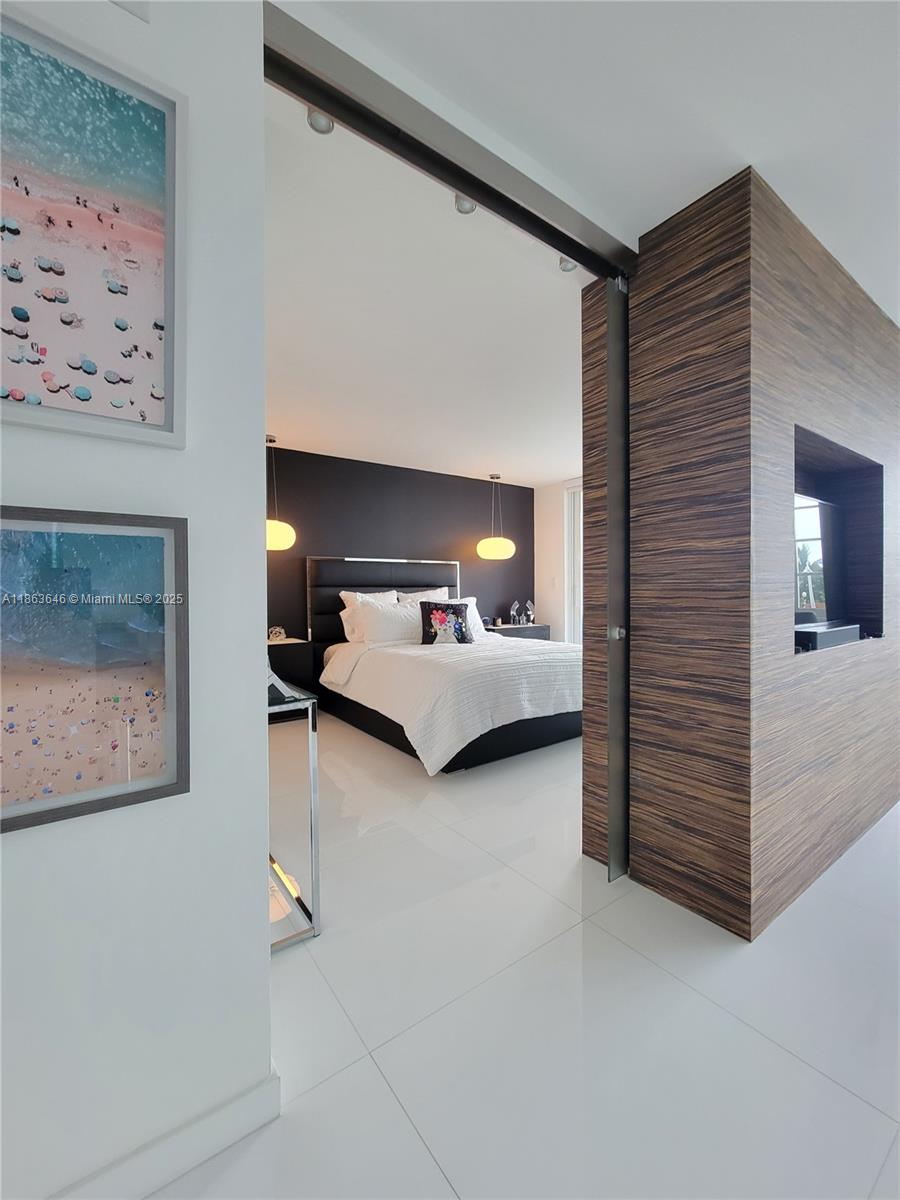 1670 Lincoln Court, Unit 3B Miami Beach, FL 33139 - Photo 7 of 13 a bedroom with furniture and a lamp