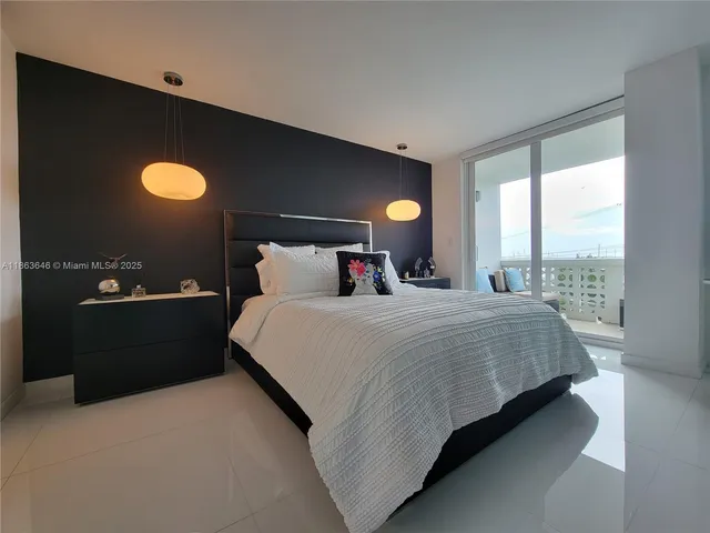 a bedroom with a bed and a lamp next to a window