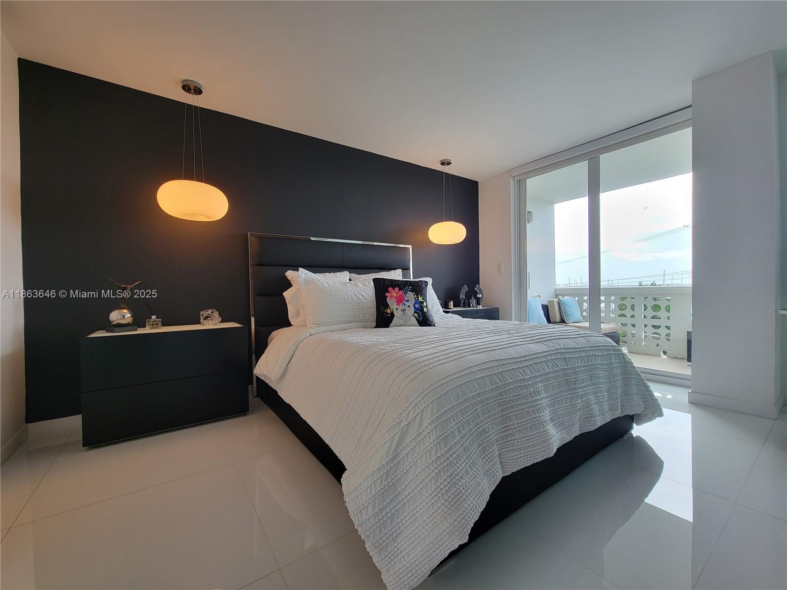 1670 Lincoln Court, Unit 3B Miami Beach, FL 33139 - Photo 8 of 13 a bedroom with a bed and a lamp next to a window