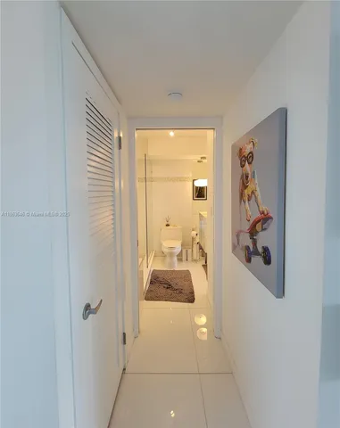 a hallway with a dining table and a mirror