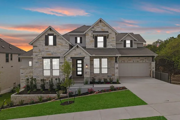 a front view of a house with a yard and garage