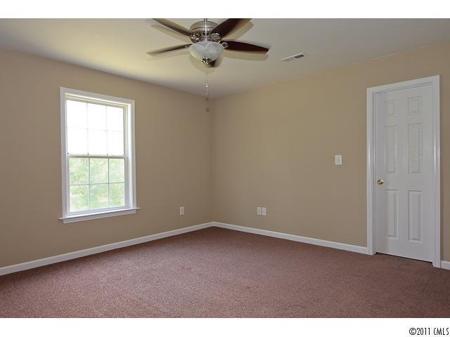 1740 Dunlap Roddey Road Rock Hill, SC 29730 - Photo 13 of 16 an empty room with a window and a ceiling fan