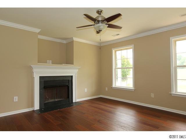 1740 Dunlap Roddey Road Rock Hill, SC 29730 - Photo 4 of 16 a view of empty room with wooden floor and fireplace