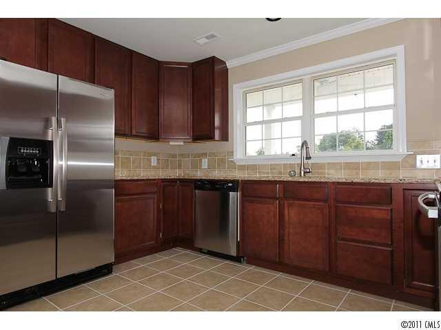 1740 Dunlap Roddey Road Rock Hill, SC 29730 - Photo 7 of 16 a kitchen with granite countertop a sink cabinets stainless steel appliances and a window