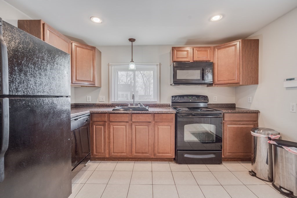 4 Jean Drive Springfield, MA 01104 - Photo 13 of 26 a kitchen with stainless steel appliances granite countertop a stove a sink and a microwave