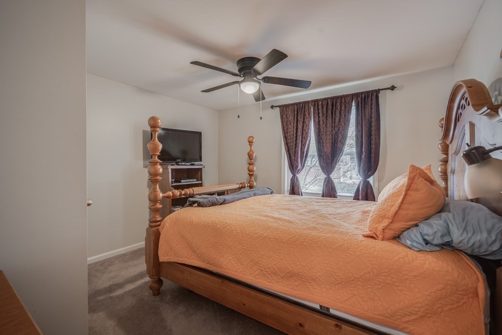 4 Jean Drive Springfield, MA 01104 - Photo 20 of 26 a bedroom with a bed and a chandelier