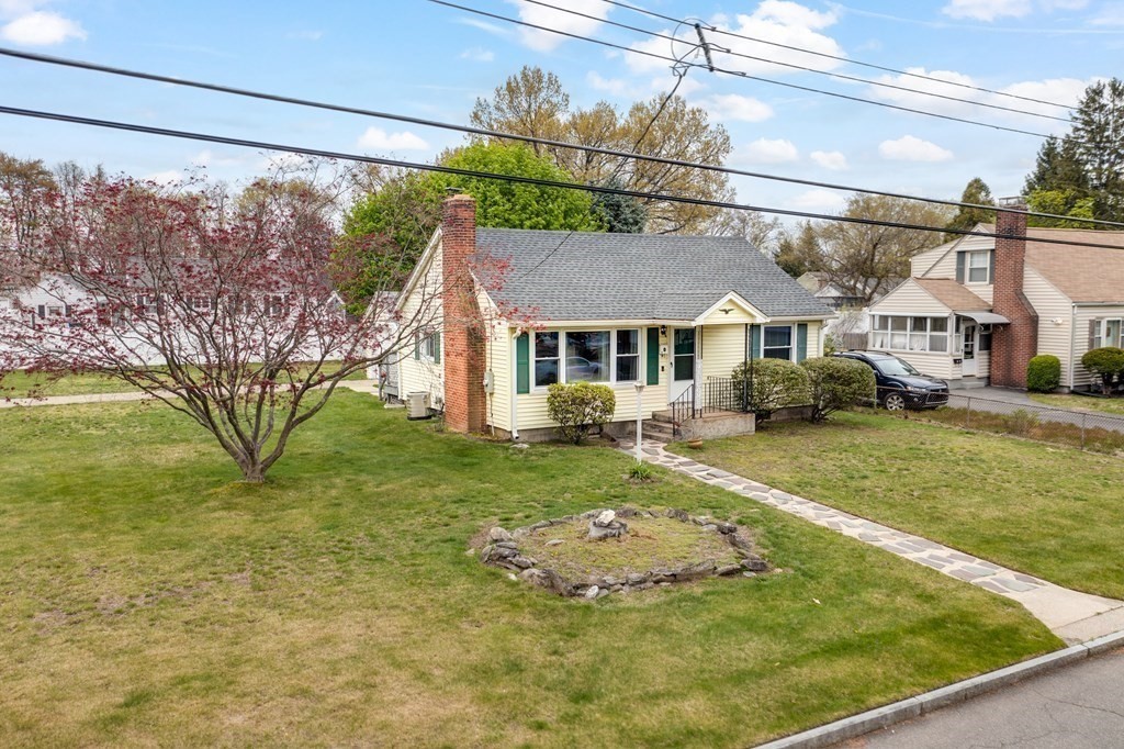 4 Jean Drive Springfield, MA 01104 - Photo 3 of 26 a view of a white house with a big yard and a large tree