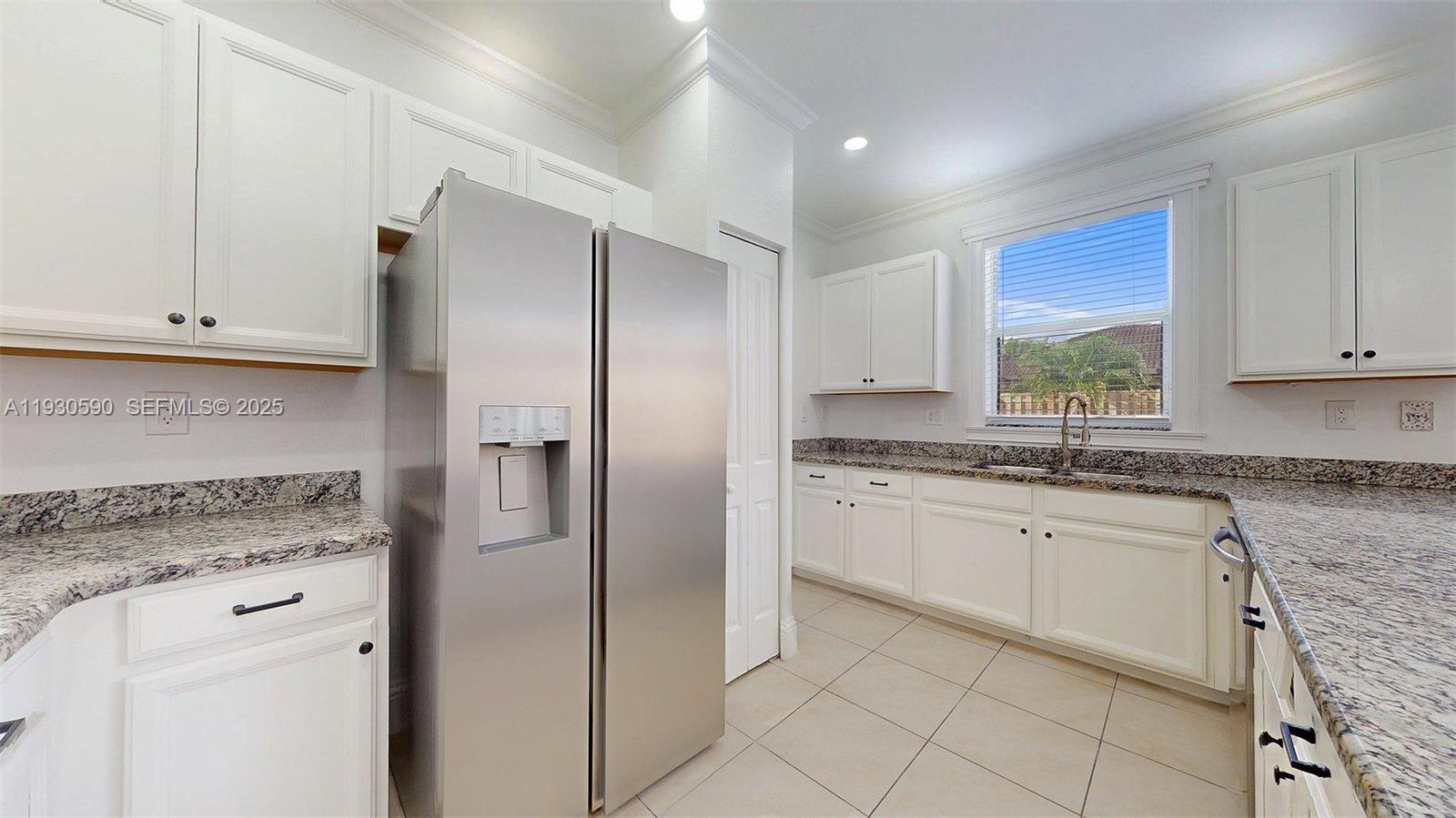 25324 Southwest 119th Avenue Homestead, FL 33032 - Photo 17 of 41 a kitchen with stainless steel appliances granite countertop a refrigerator and white cabinets