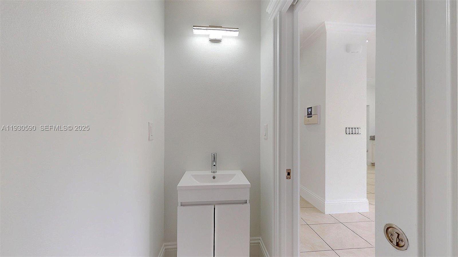 25324 Southwest 119th Avenue Homestead, FL 33032 - Photo 19 of 41 a bathroom with a sink and mirror