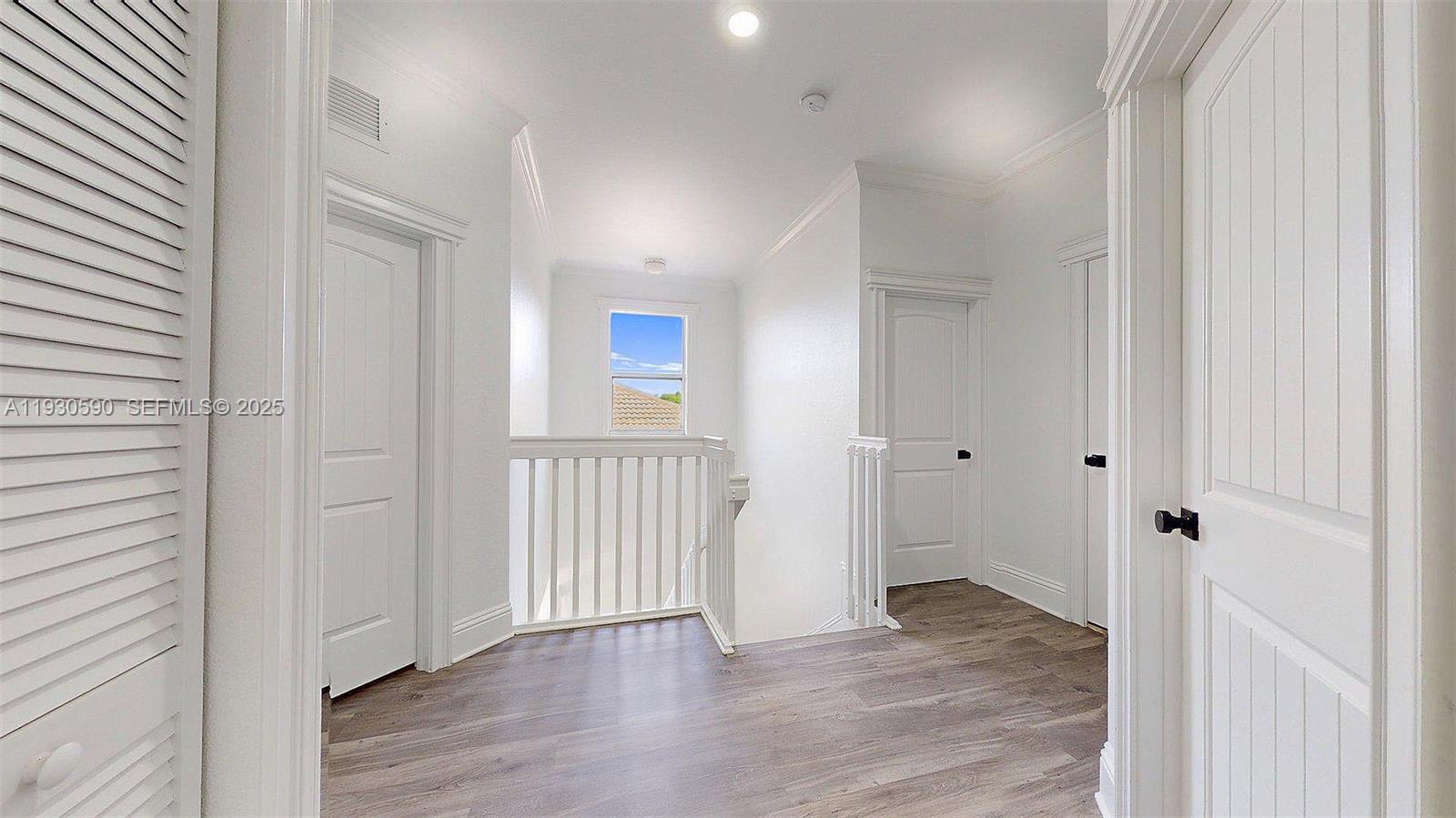 25324 Southwest 119th Avenue Homestead, FL 33032 - Photo 21 of 41 a view of a hallway with wooden floor
