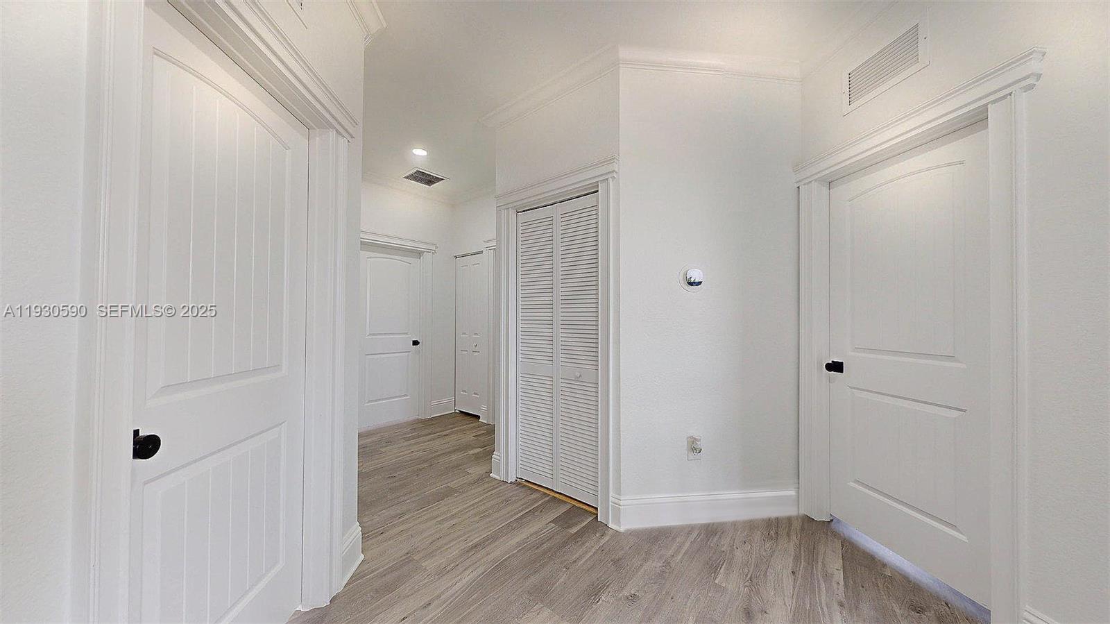 25324 Southwest 119th Avenue Homestead, FL 33032 - Photo 22 of 41 a view of a hallway with wooden floor