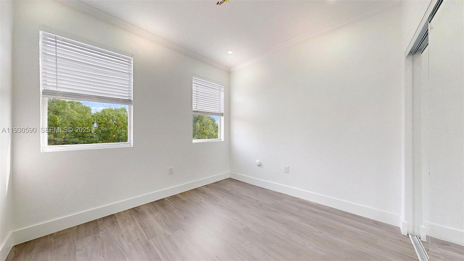 25324 Southwest 119th Avenue Homestead, FL 33032 - Photo 26 of 41 an empty room with wooden floor and window